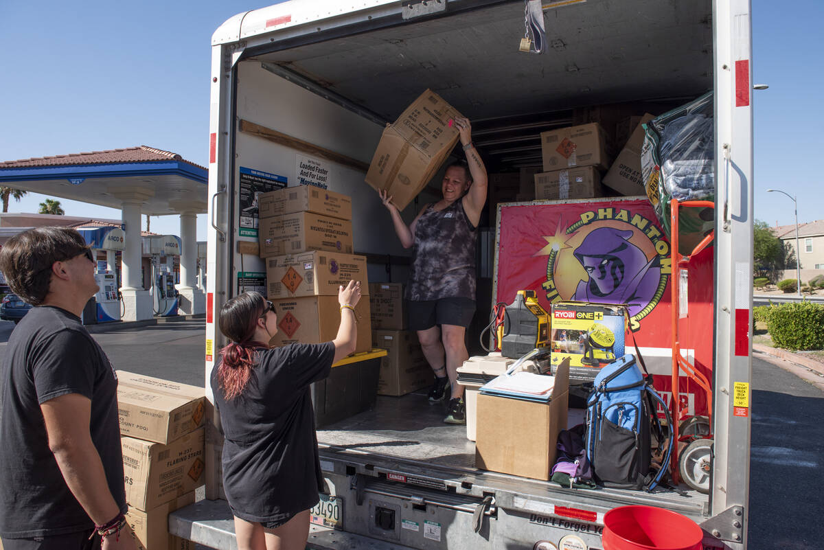 Roman Sicho, left, and Hannah Dockery help Amy Dockery, right, unload their rental truck as the ...