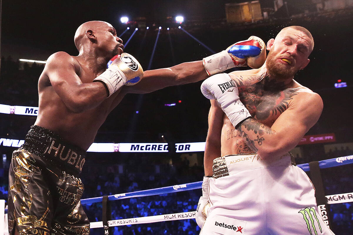 Floyd Mayweather, left, lands a punch against Conor McGregor on Saturday, Aug 26, 2017, at T-Mo ...