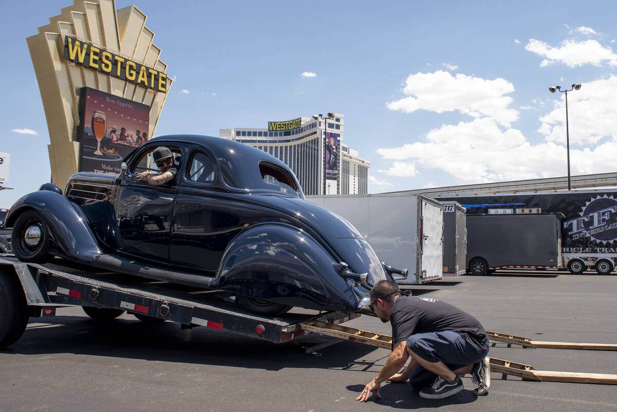 Dan Hogan, left, of Phoenix unloads a 1936 Ford Coupe with help from Anthony Filardi, center, a ...