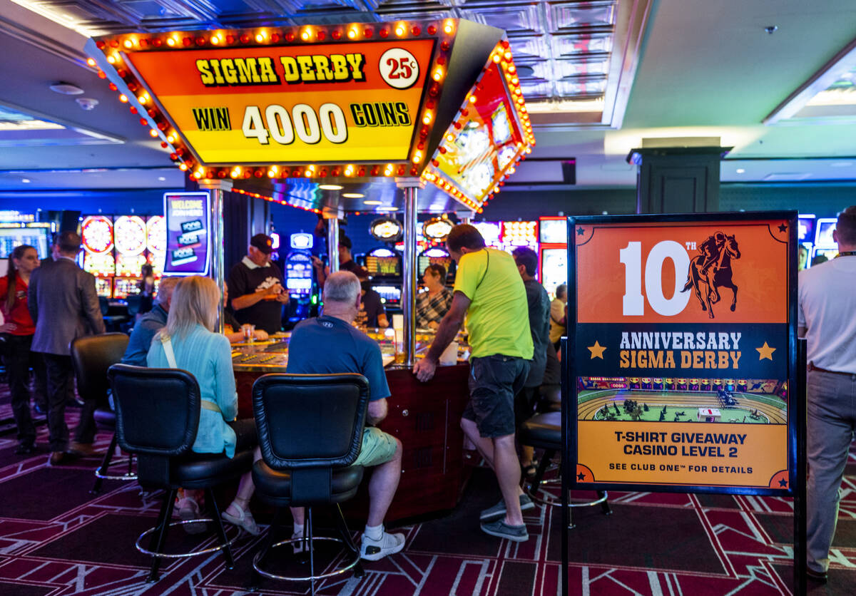 Players cheer on their horses in the U.S.’ only remaining Sigma Derby racing machine on ...