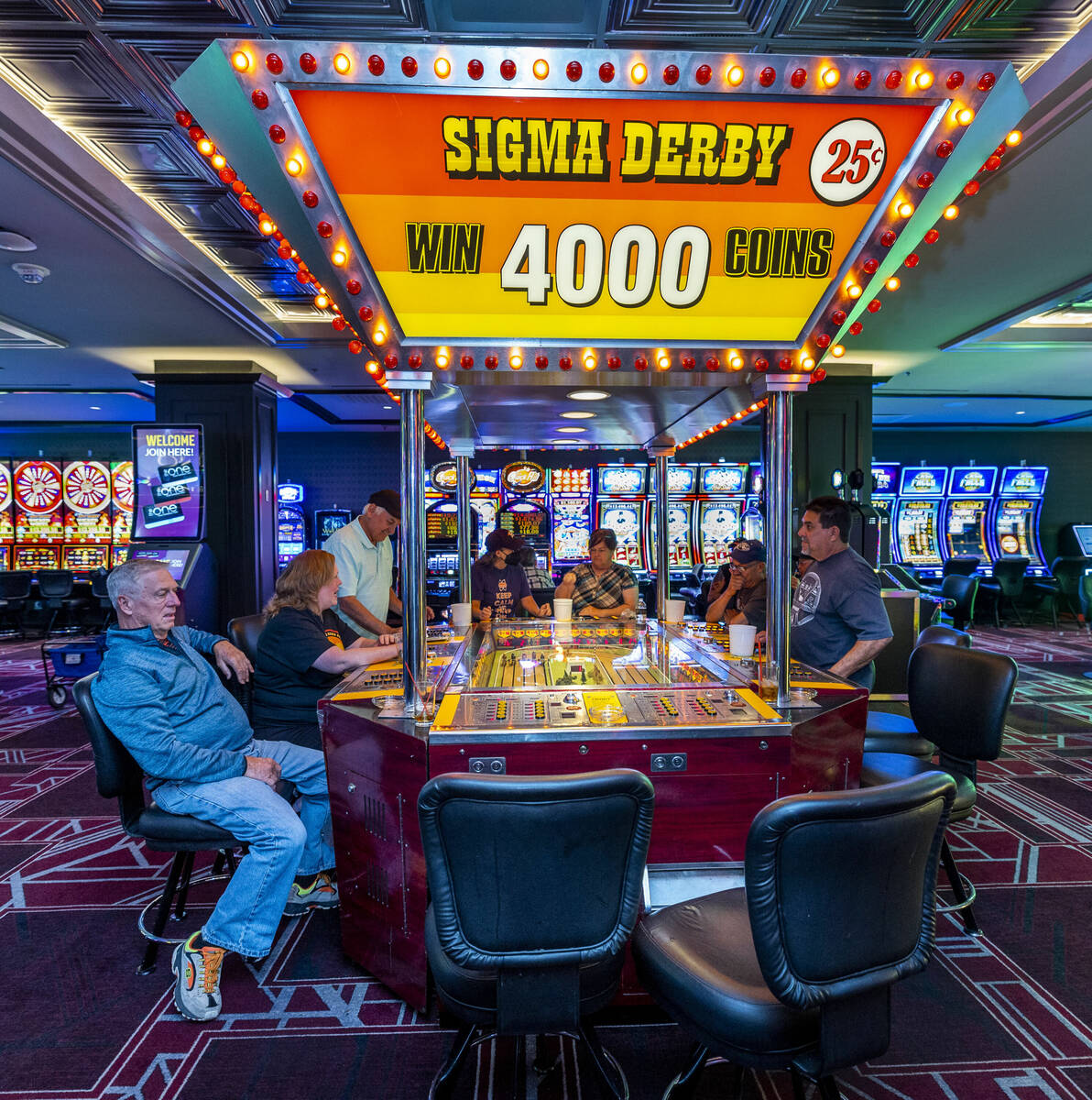 Players watch their horses in the U.S.’ only remaining Sigma Derby racing machine on its ...