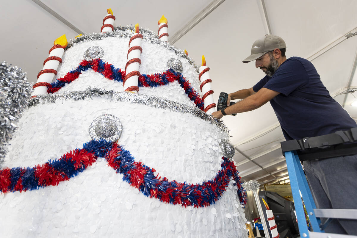 Maintenance coordinators Dave Bailey puts the finishing touches on a float during a Summerlin P ...