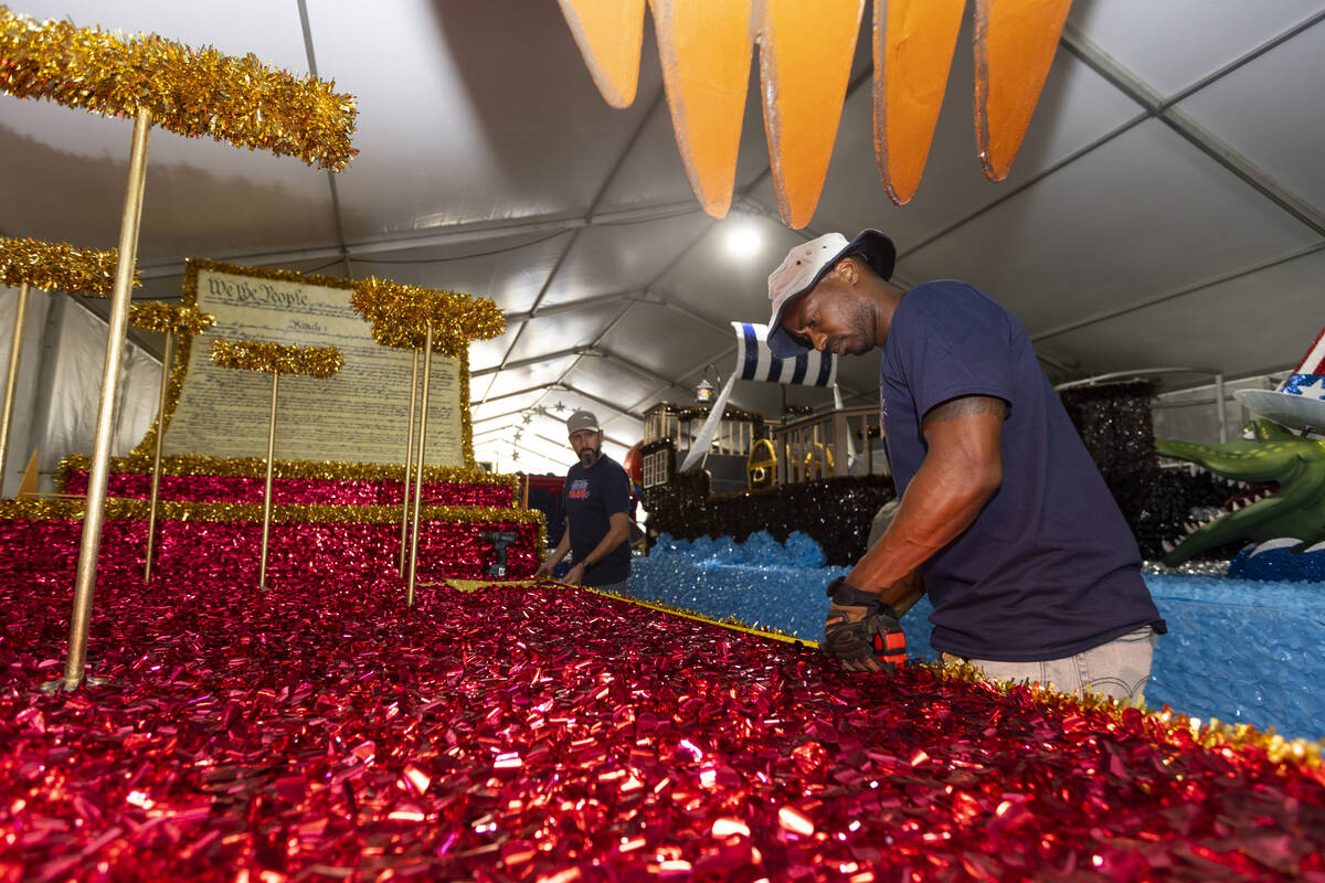 Maintenance coordinators Dave Bailey, left, and Isiah Powell put the finishing touches on a flo ...