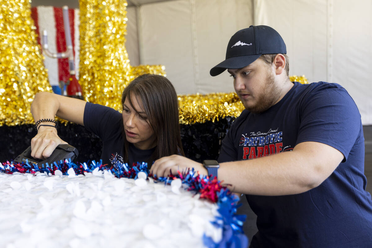 Summerlin Council volunteers Brooke Pizzo, left, and Ben Bell put the finishing touchdown on a ...