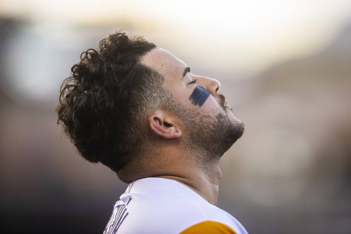 Aviators infielder Vimael Machin (9) prays before the start of a minor league baseball game aga ...
