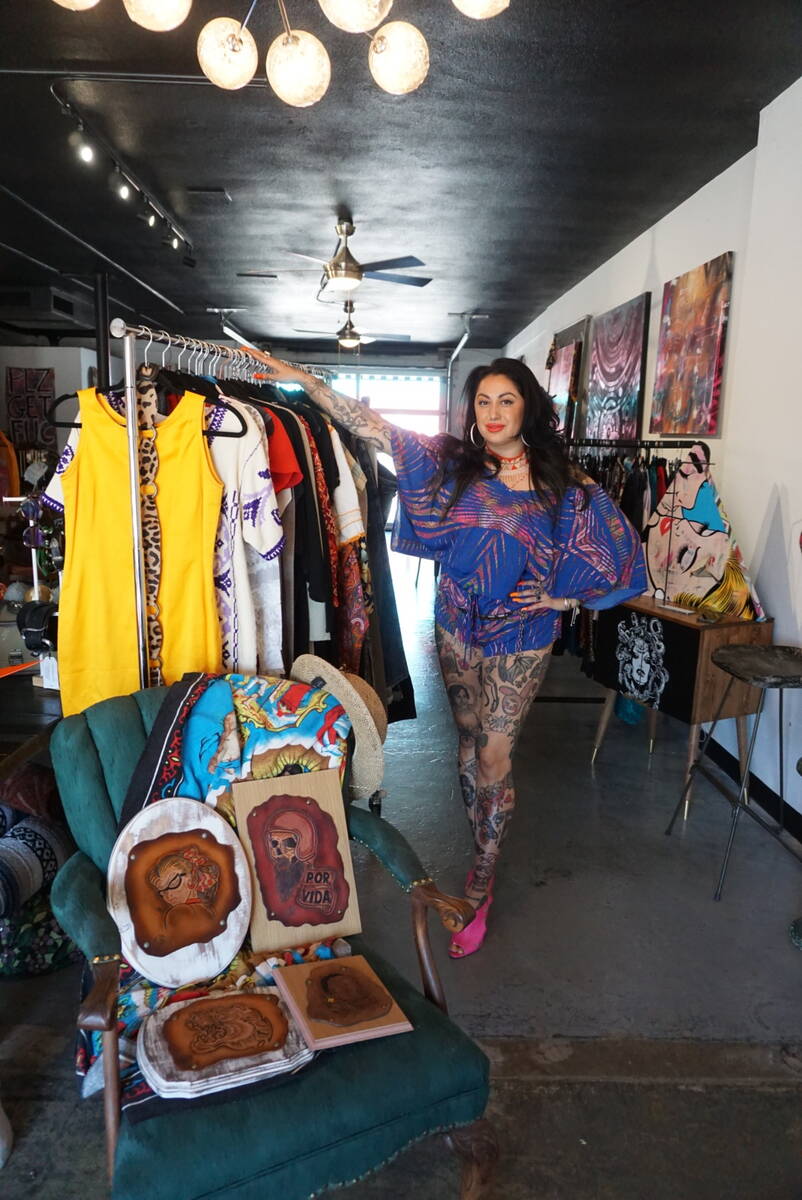 Ruby Romero poses next to a selection of vintage clothes in Sin Amor Studio, in the Arts Distri ...