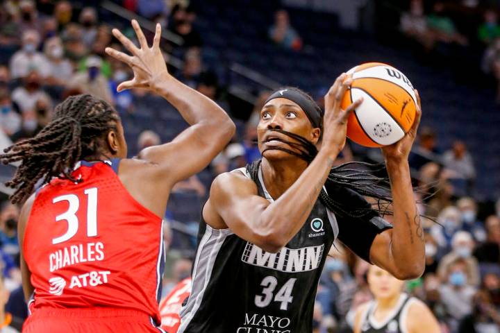 Minnesota Lynx center Sylvia Fowles (34) shoots over Washington Mystics center Tina Charles (31 ...