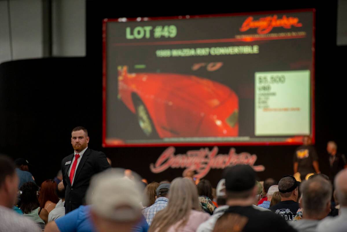 Auction staff keeps an eye out for bids during opening day of the Barrett-Jackson car auction a ...
