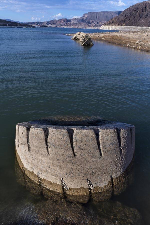 A WWII-era landing craft used to transport troops or tanks and large tire nearby being revealed ...