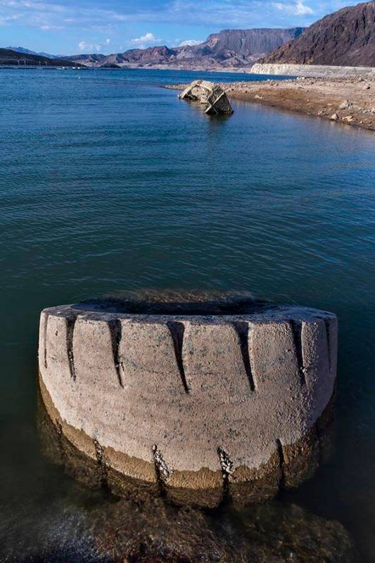 A WWII-era landing craft used to transport troops or tanks, and large tire nearby, are being re ...
