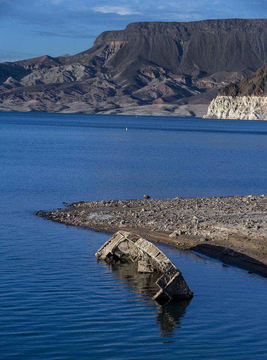 A WWII-era landing craft used to transport troops or tanks being revealed on the shoreline near ...