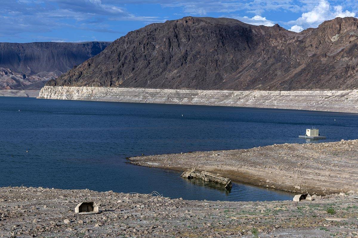A WWII-era landing craft used to transport troops or tanks is being revealed on the shoreline n ...