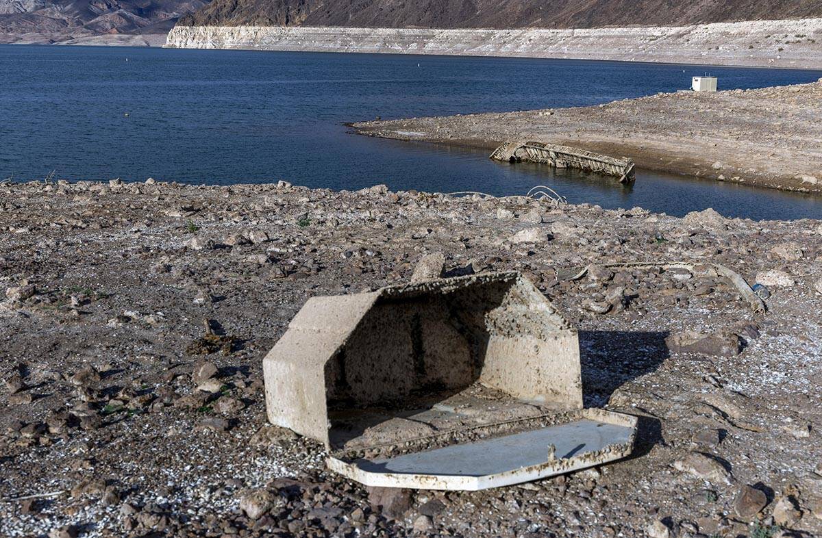 A WWII-era landing craft used to transport troops or tanks is being revealed on the shoreline n ...