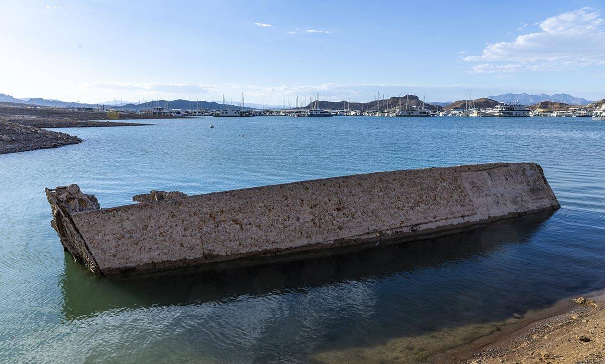 A WWII landing craft used to transport troops or tanks is being revealed on the shoreline near ...