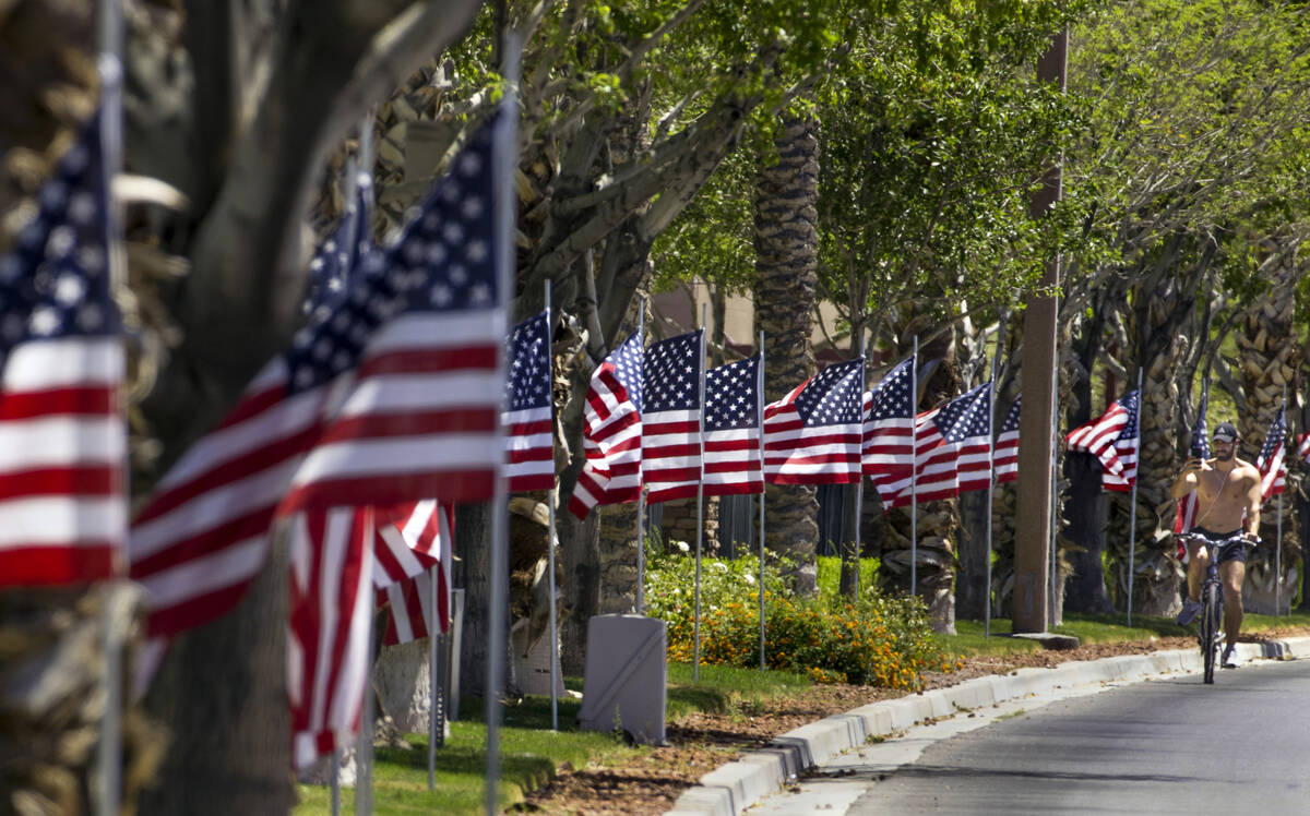 In this July 4, 2020, file photo, Ruben Kihuen shoots some video as he rides past the Flags Ove ...