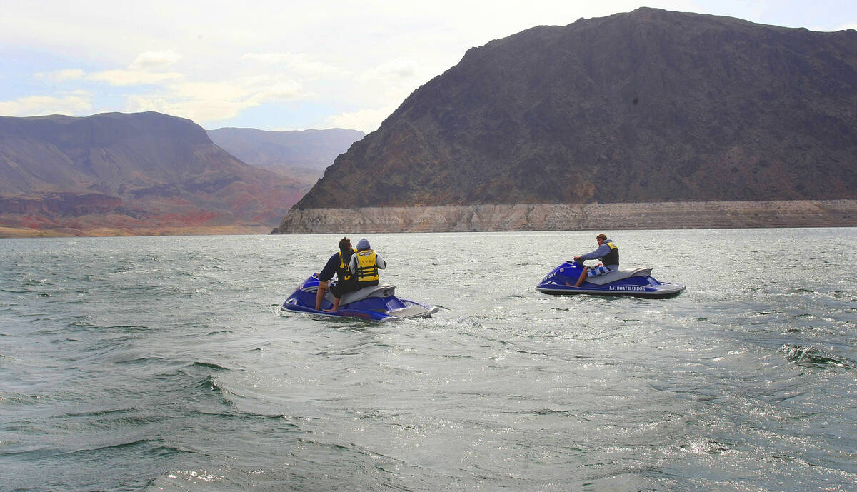 A pair of jet skiers float in Hemenway Harbor in the Lake Mead National Recreation Area on Frid ...