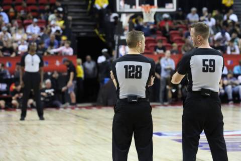 Referees discuss during a timeout in the Vegas Summer League game between the Washington Wizard ...