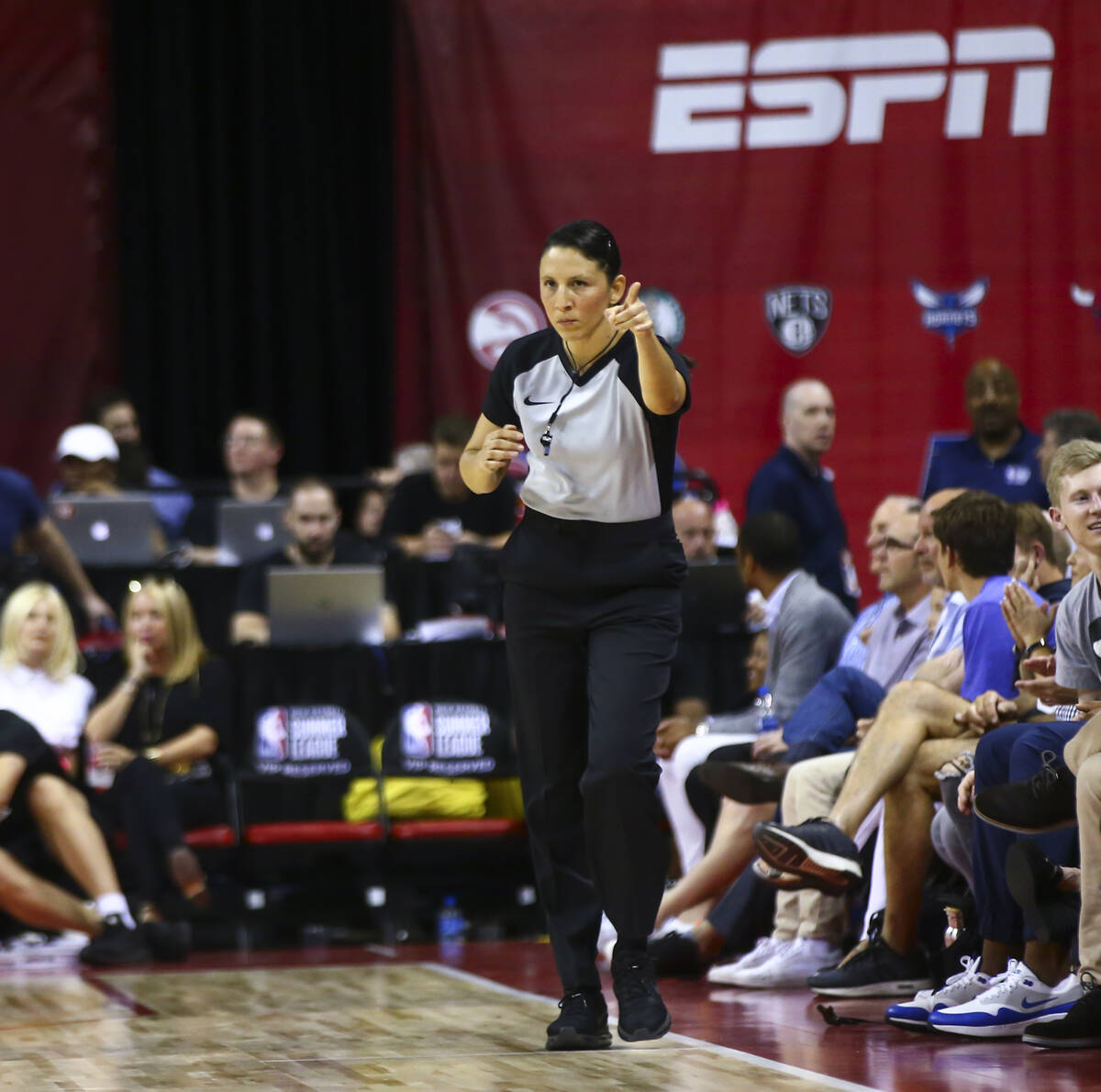 Referee Hortencia Sanchez-Carrizales motions while officiating a game between Phoenix Suns and ...