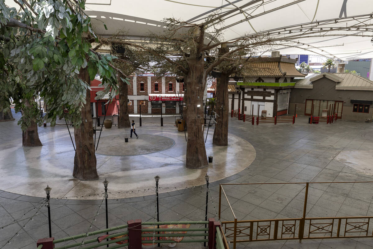 A pedestrian takes a shortcut through the closed Hawaiian Marketplace, Wednesday, June 29, 2022 ...