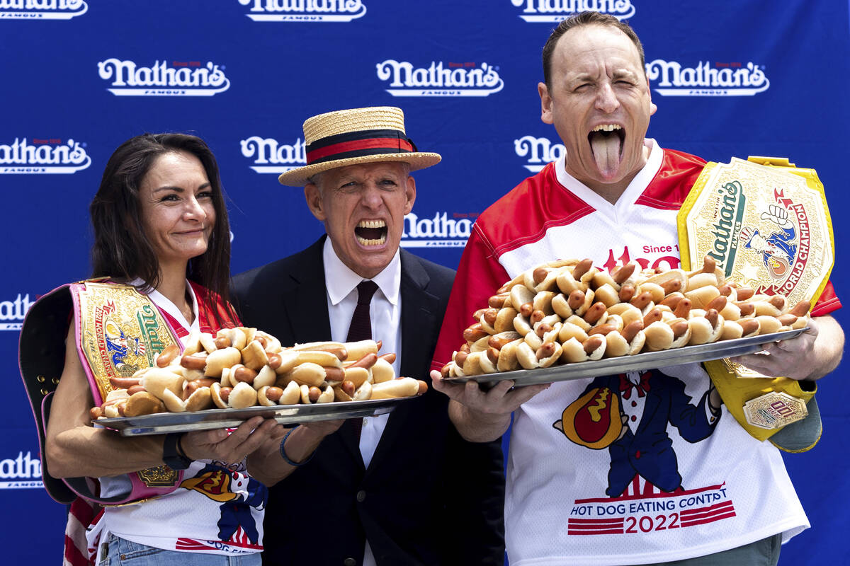 Competitive eaters Michelle Lesco and Joey Chestnut pose for photos with their record number of ...