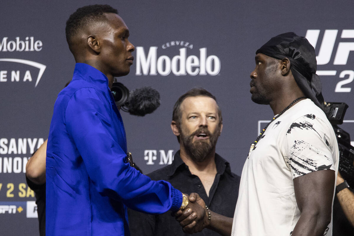 Israel Adesanya, left, and Jared Cannonier, face off during an UFC 276 press conference at T-Mo ...