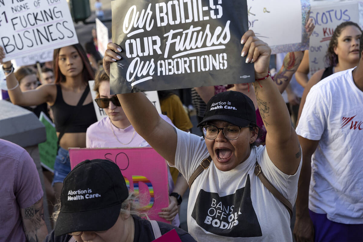 Elizabeth Murillo, of Las Vegas, right, chants during a rally for women’s rights, Friday ...