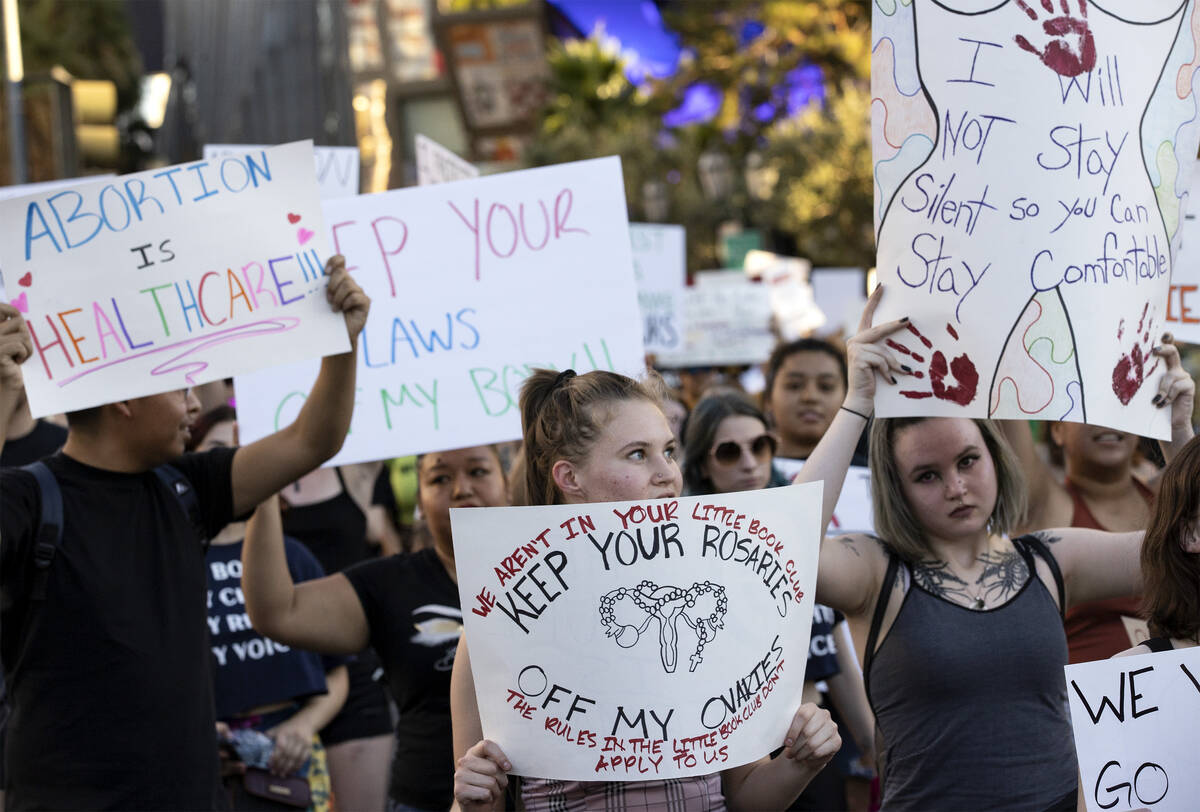 Attendees of a rally for women’s rights cross Bellagio Drive, Friday, July 1, 2022, on t ...