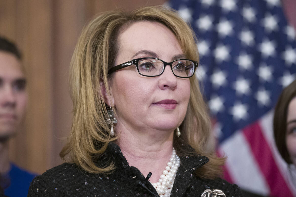 FILE - Former Rep. Gabby Giffords, stands during a news conference to announce the introduction ...