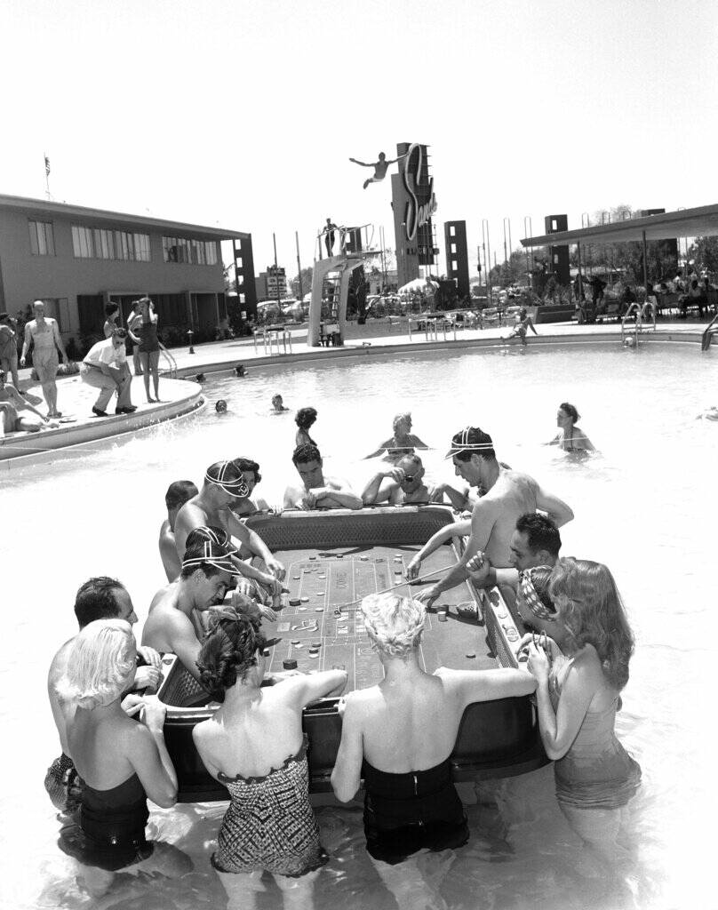 Guests at the Sands Hotel enjoy gambling in the swimming pool on July 13, 1953. The dealers' sp ...