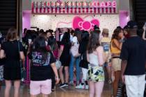 Customers spill out of the new Hello Kitty Cafe during the grand opening inside Fashion Show Ma ...