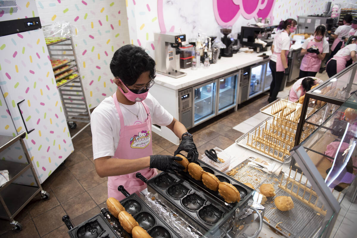 Rochaun Soberano works to make the waffle-batter shells for the cafe's signature treat, soft se ...