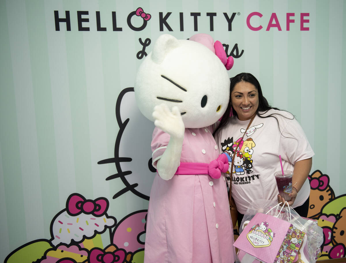 Sandra Ornelas poses for a photo with Hello Kitty during the grand opening of the new Hello Kit ...