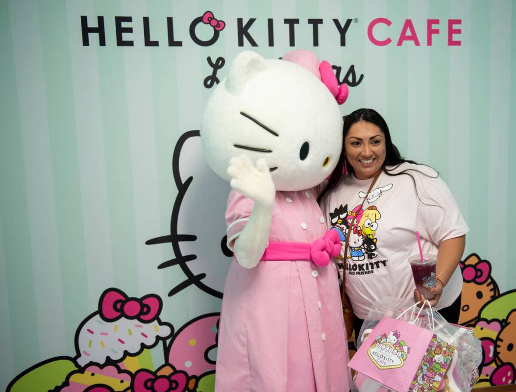 Sandra Ornelas poses for a photo with Hello Kitty during the grand opening of the new Hello Kit ...