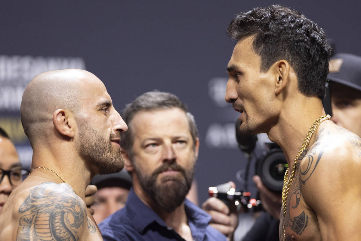 Alexander Volkanovski, left, and Max Holloway, face off during an UFC 276 weigh-in event at T-M ...