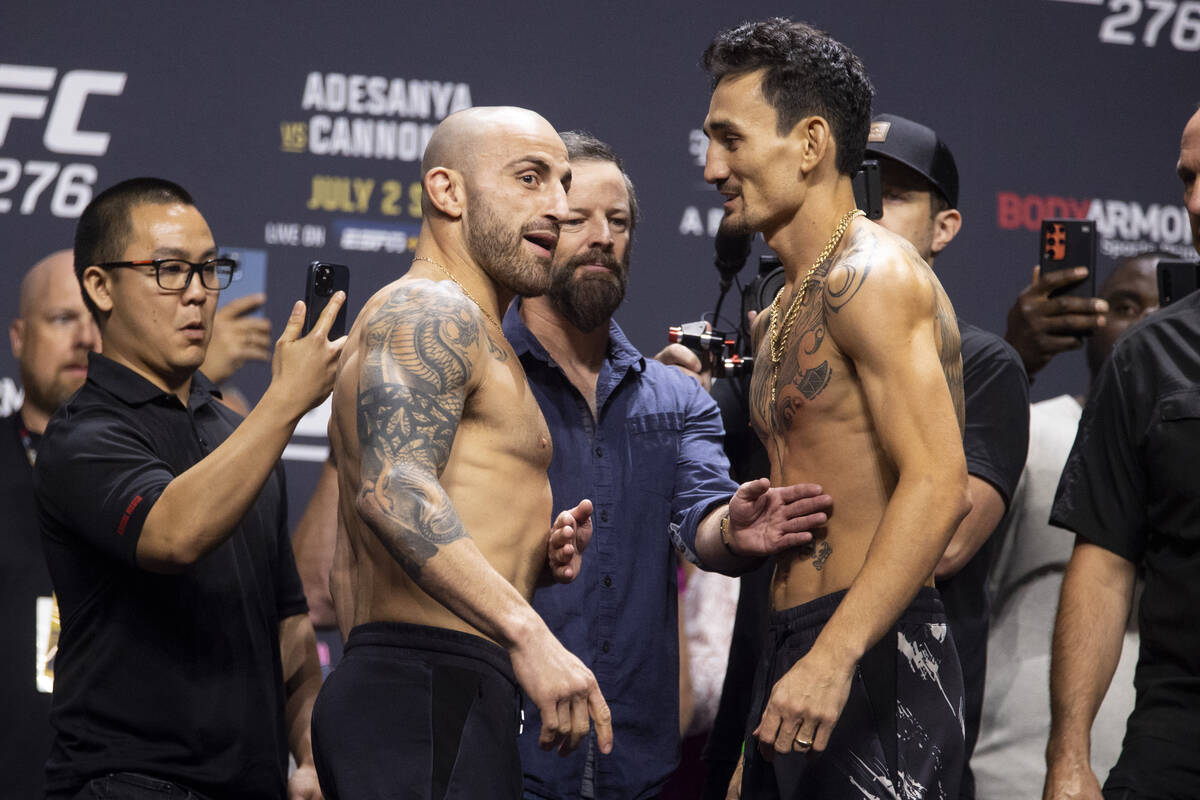Alexander Volkanovski, left, and Max Holloway, face off during an UFC 276 weigh-in event at T-M ...