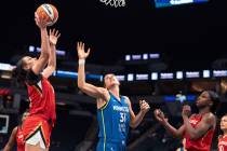 Las Vegas Aces forward Dearica Hamby (5) shoots next to Minnesota Lynx center Nikolina Milic (3 ...