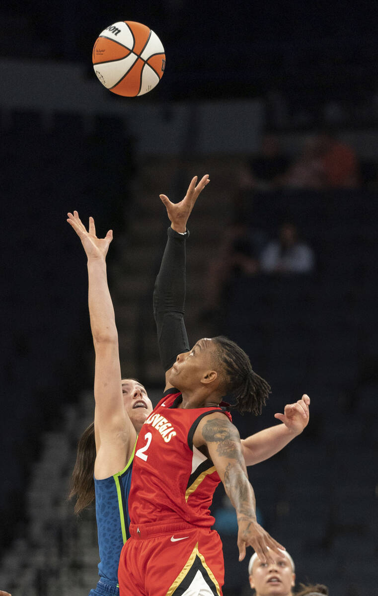 Minnesota Lynx forward Bridget Carleton and Las Vegas Aces guard Riquna Williams (2) reach for ...