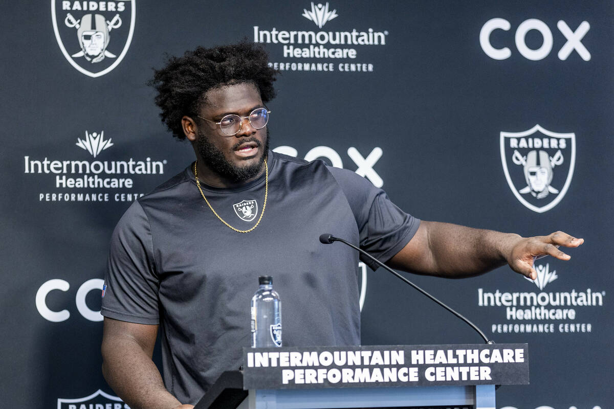 Raiders offensive lineman Alex Leatherwood (70) answers a media question during minicamp practi ...