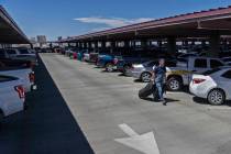 A passenger walks to the elevator in the Terminal 1 parking garage at McCarran International Ai ...