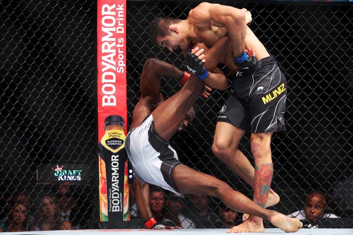 Andre Muniz, right, takes down Uriah Hall, during the third round in a middleweight bout at T-M ...