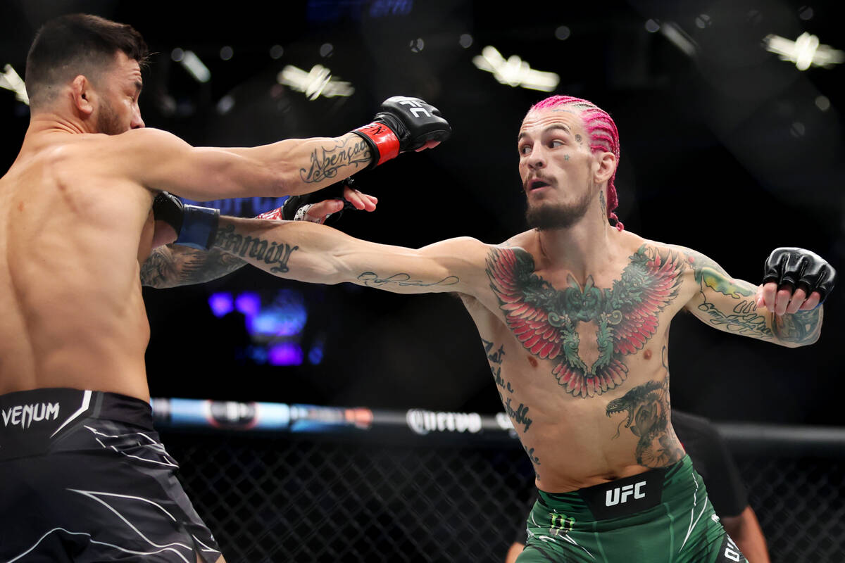 Sean O'Malley, right, throws a punch against Pedro Munhoz during the first round in a bantamwei ...