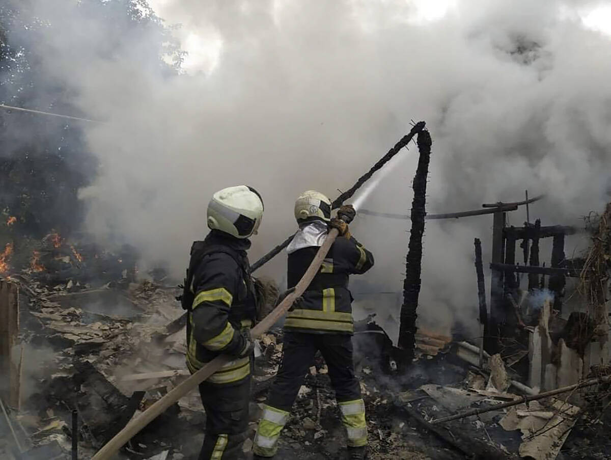 In this photo provided by the Luhansk region military administration, Ukrainian firefighters wo ...