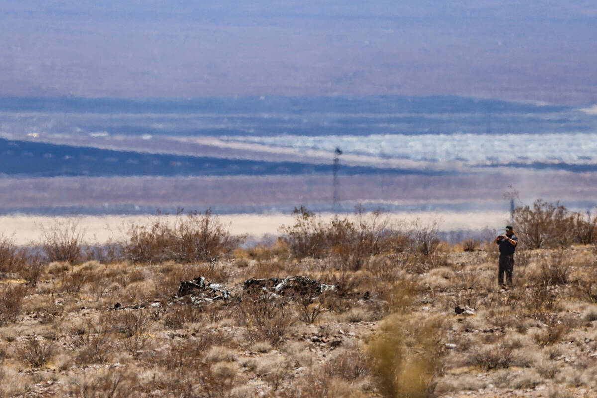 Investigators work the scene where a small aircraft crashed, killing its pilot, near Boulder Ci ...