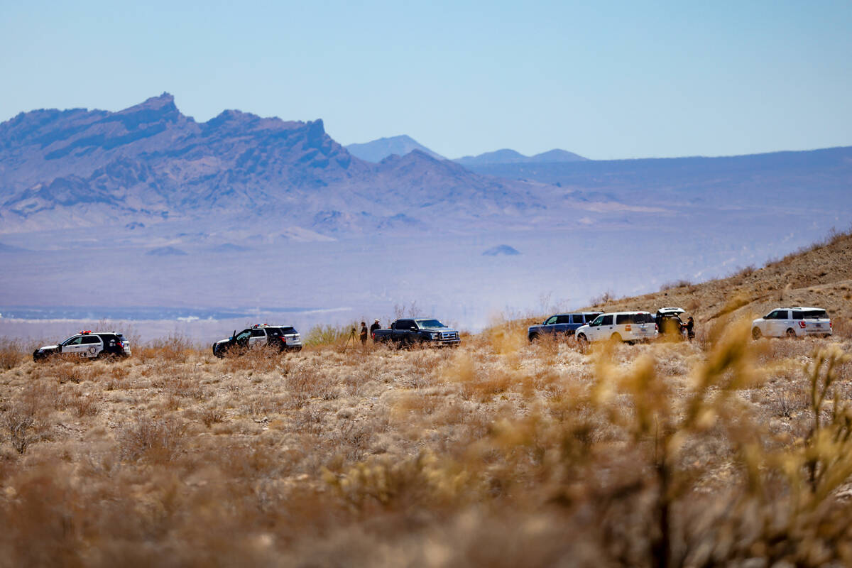 Investigators work the scene where a small aircraft crashed, killing its pilot, near Boulder Ci ...