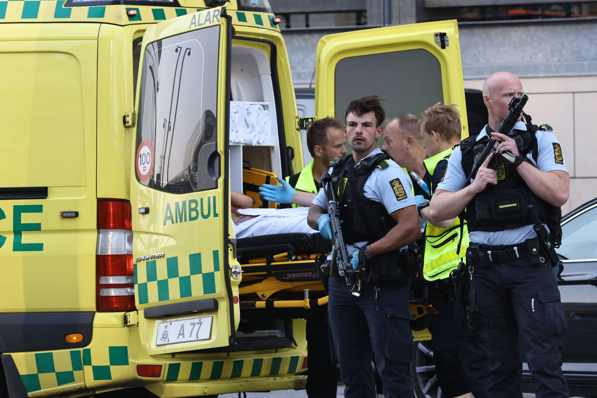 An ambulance and armed police outside the Field's shopping center, in Orestad, Copenhagen, Denm ...