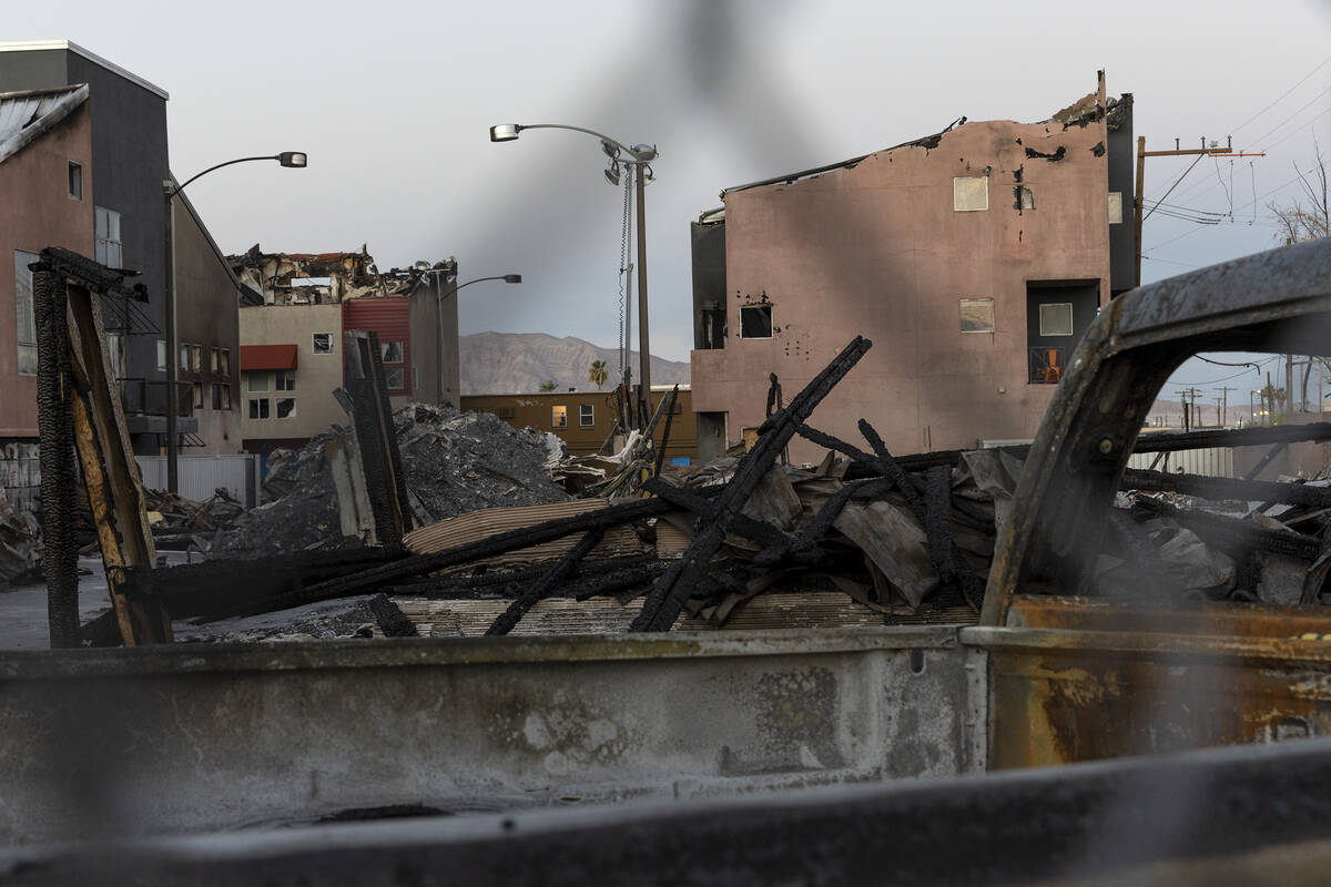 Burned remnants of Urban Lofts Townhomes are fenced off on Wednesday, June 29, 2022, in downtow ...