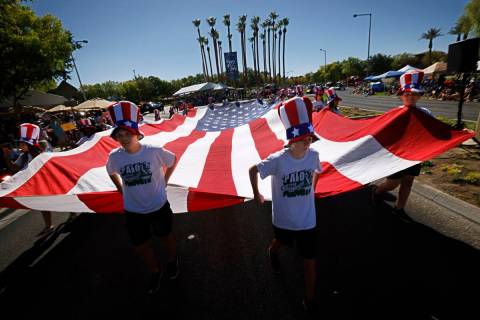 Palo Verde High School Cross Country Panthers members carry a large American flag during the 28 ...