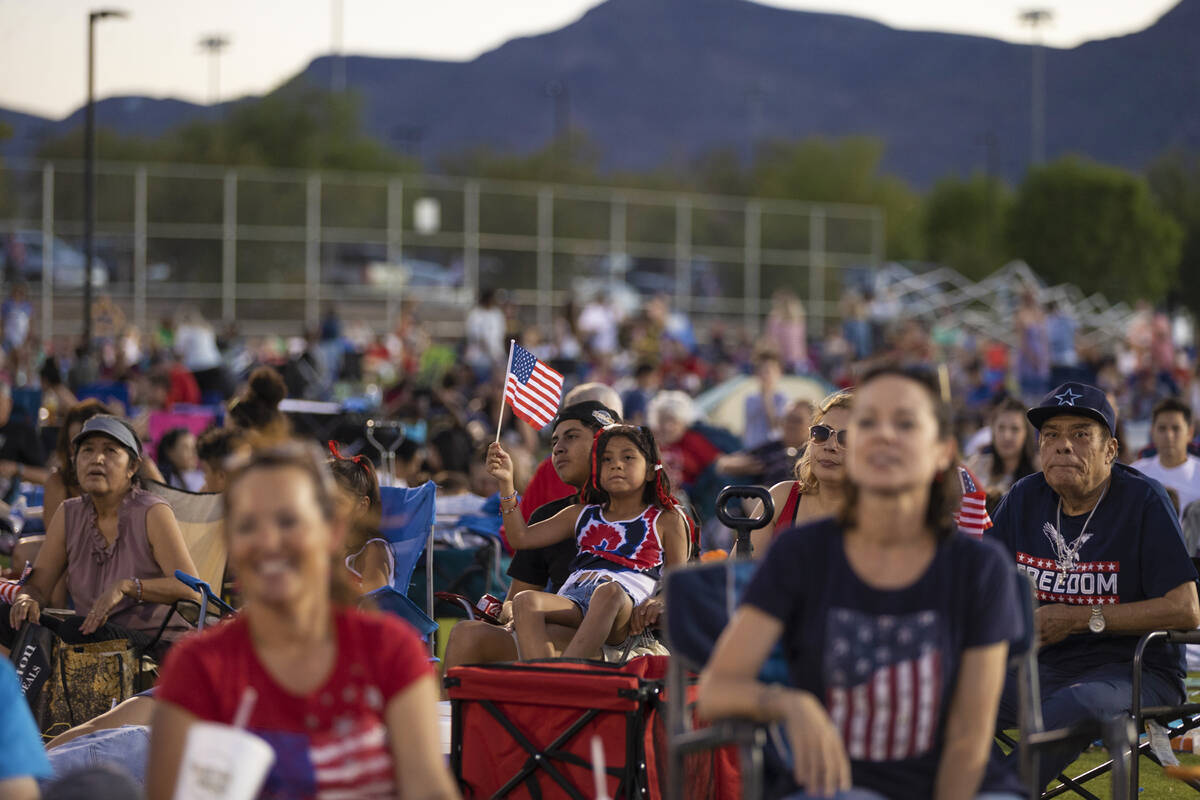 Emily Sandoval, holding flag, 9, waits for the fireworks to start during a Fourth of July celeb ...