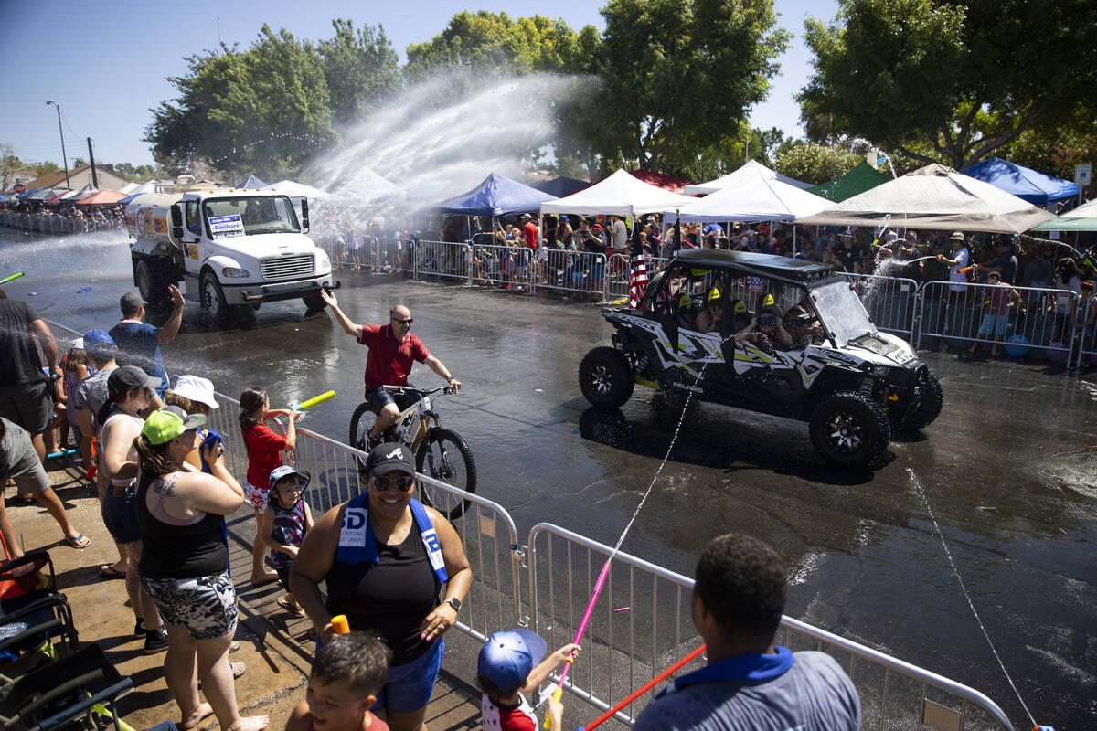 People spray water following the Boulder City's 74th annual 4th of July Parade in Boulder City, ...