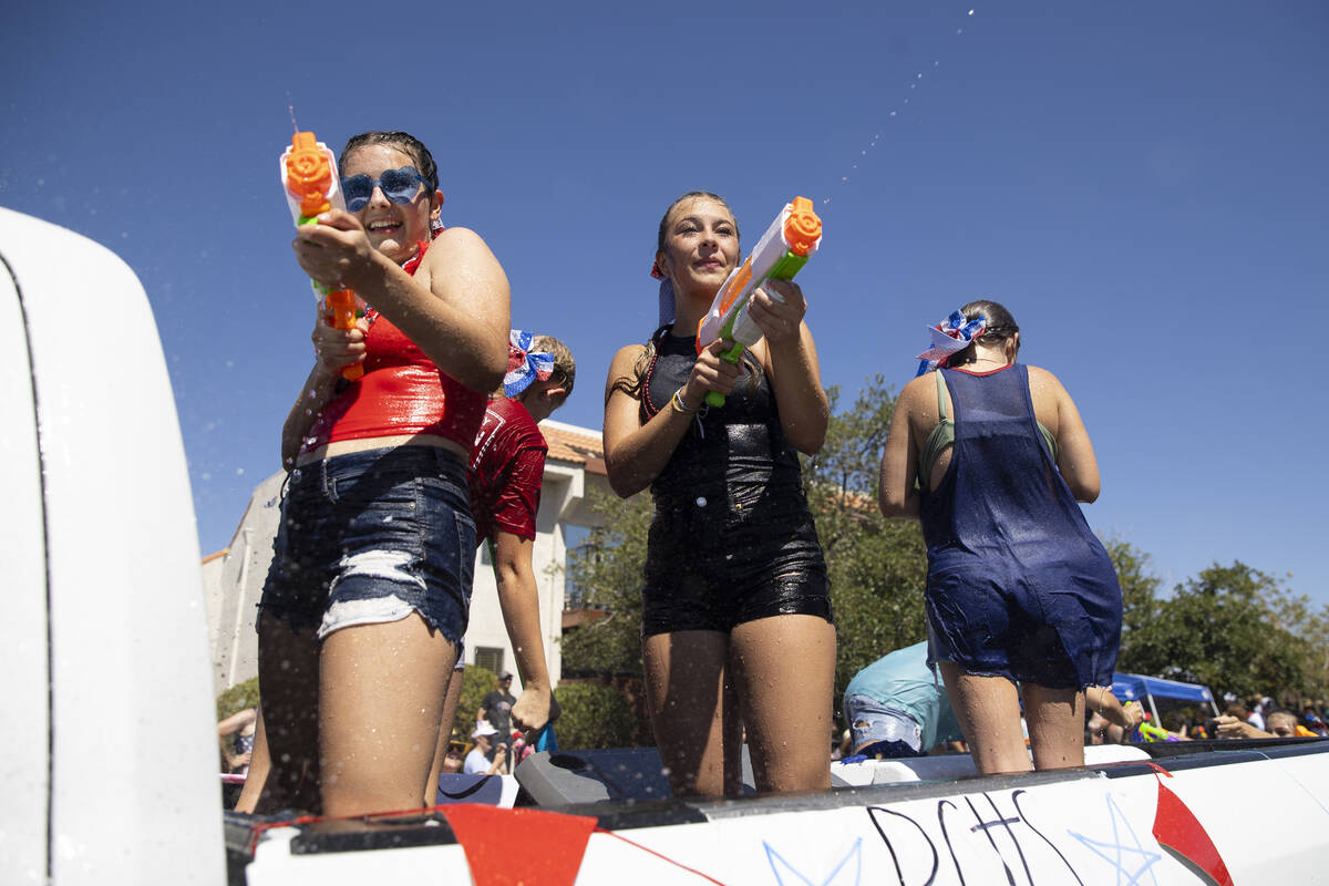 People spray water following the Boulder City's 74th annual 4th of July Parade in Boulder City, ...